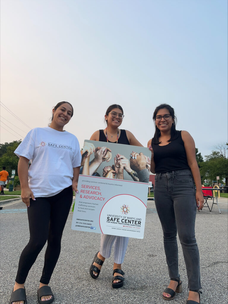 Volunteers holding the SAFE center sign